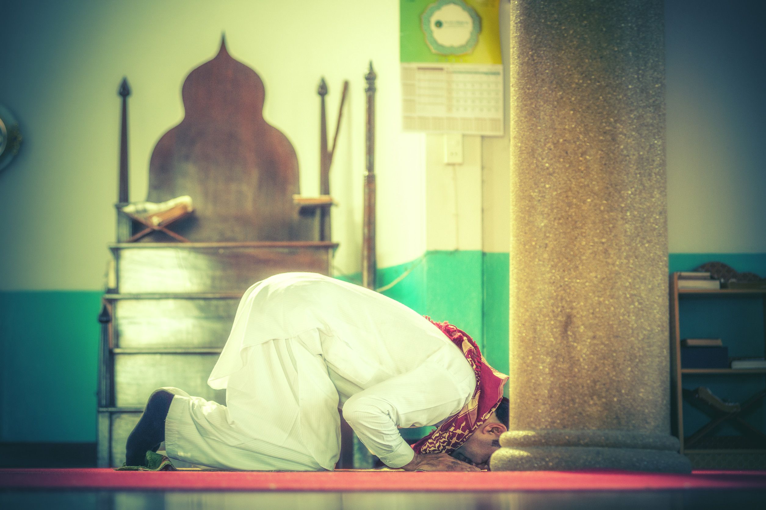 A Devout Muslim Man Engaged In Prayer Within The Mosque A Devout Muslim Man Engaged In Prayer Within The Mosque
