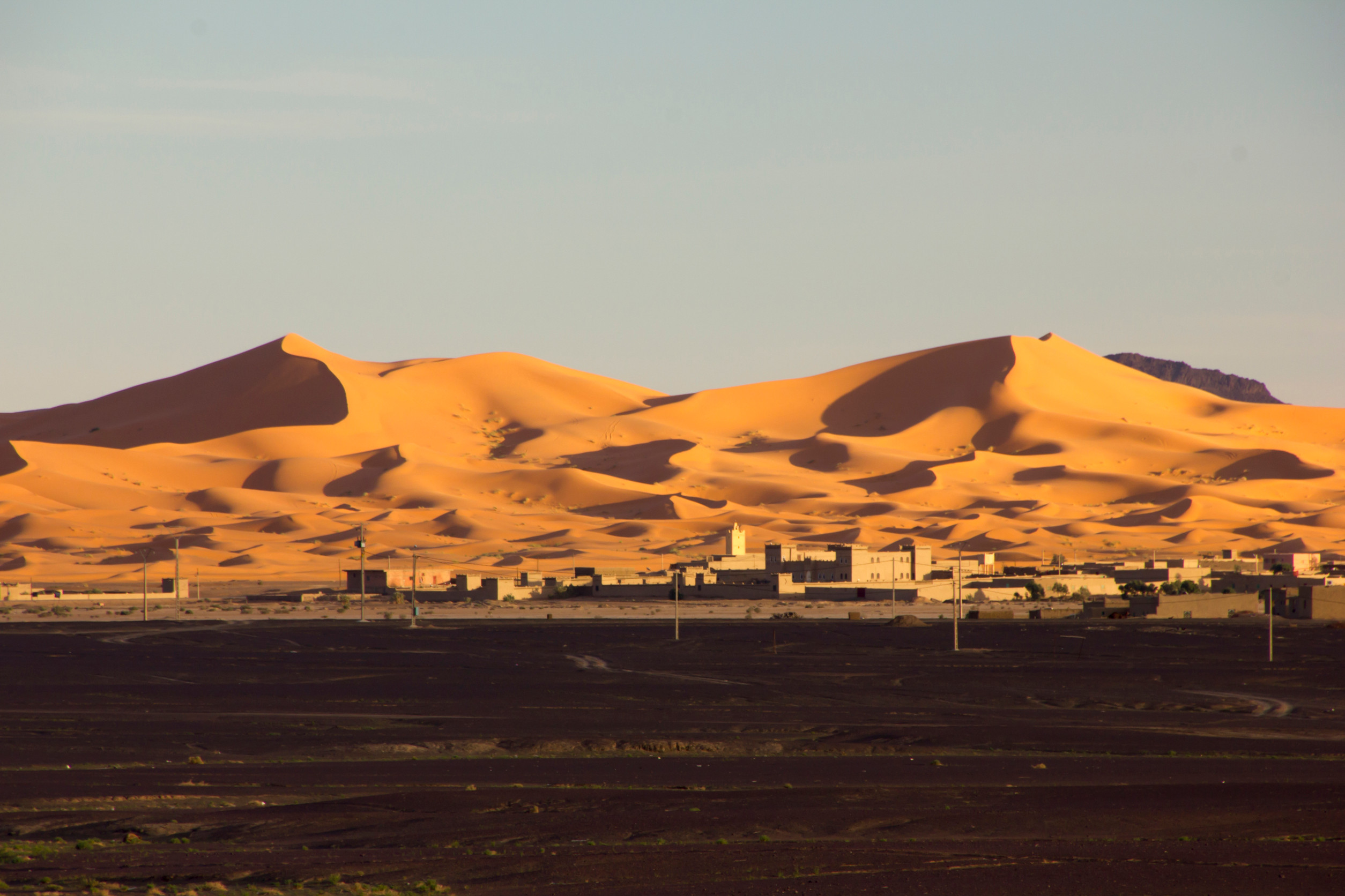 Merzouga village with desert dunes