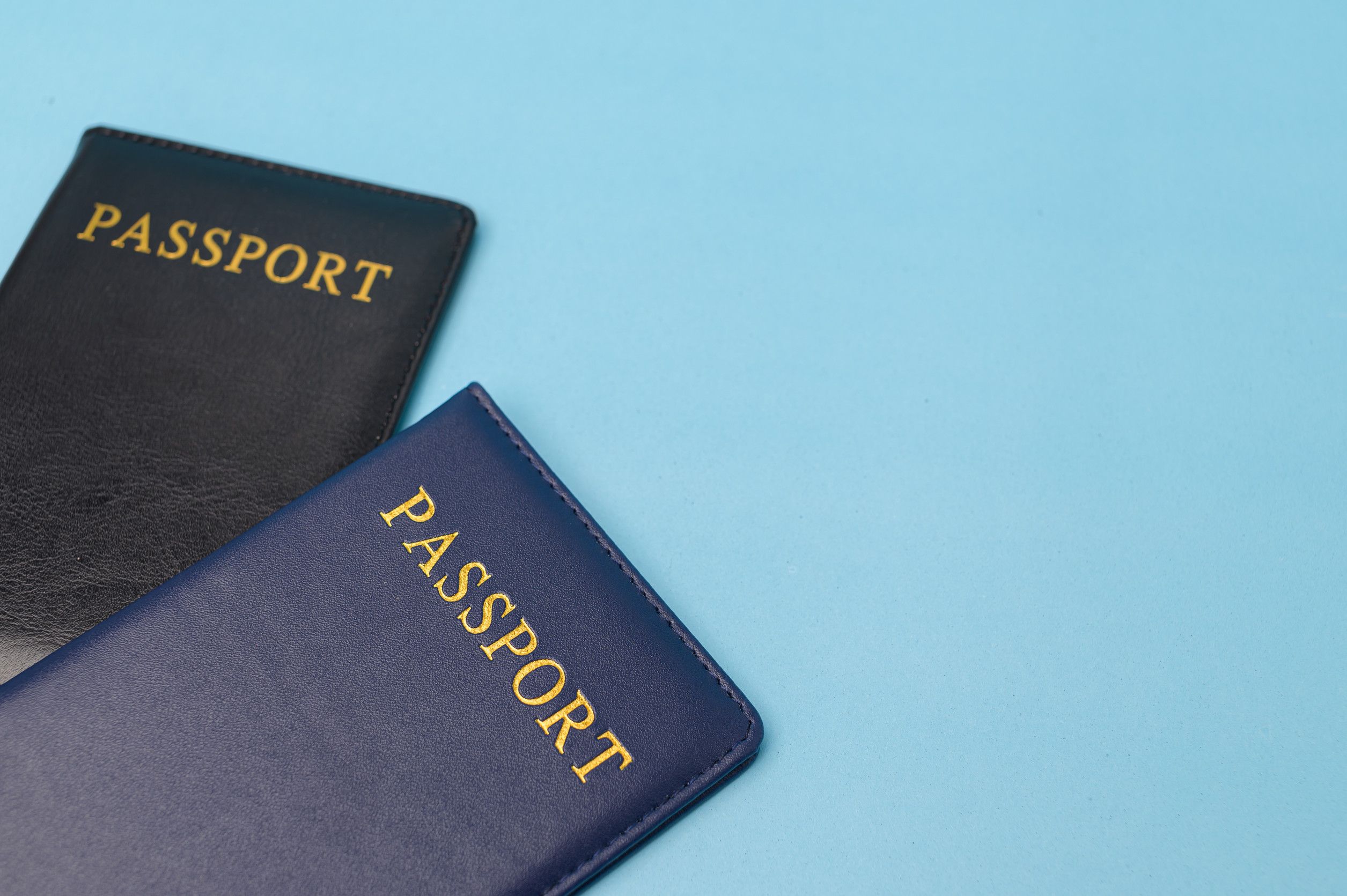 Two Passports On Blue Background Two Passports On Blue Background